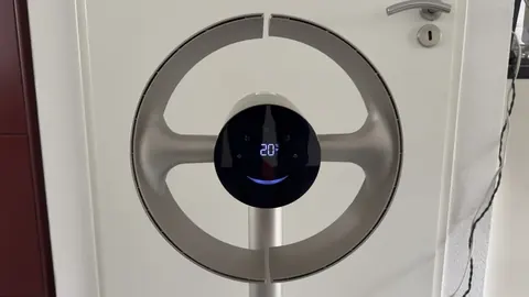 De Dreame MF10 van voren, met de ring en het ronde display voor een witte deur